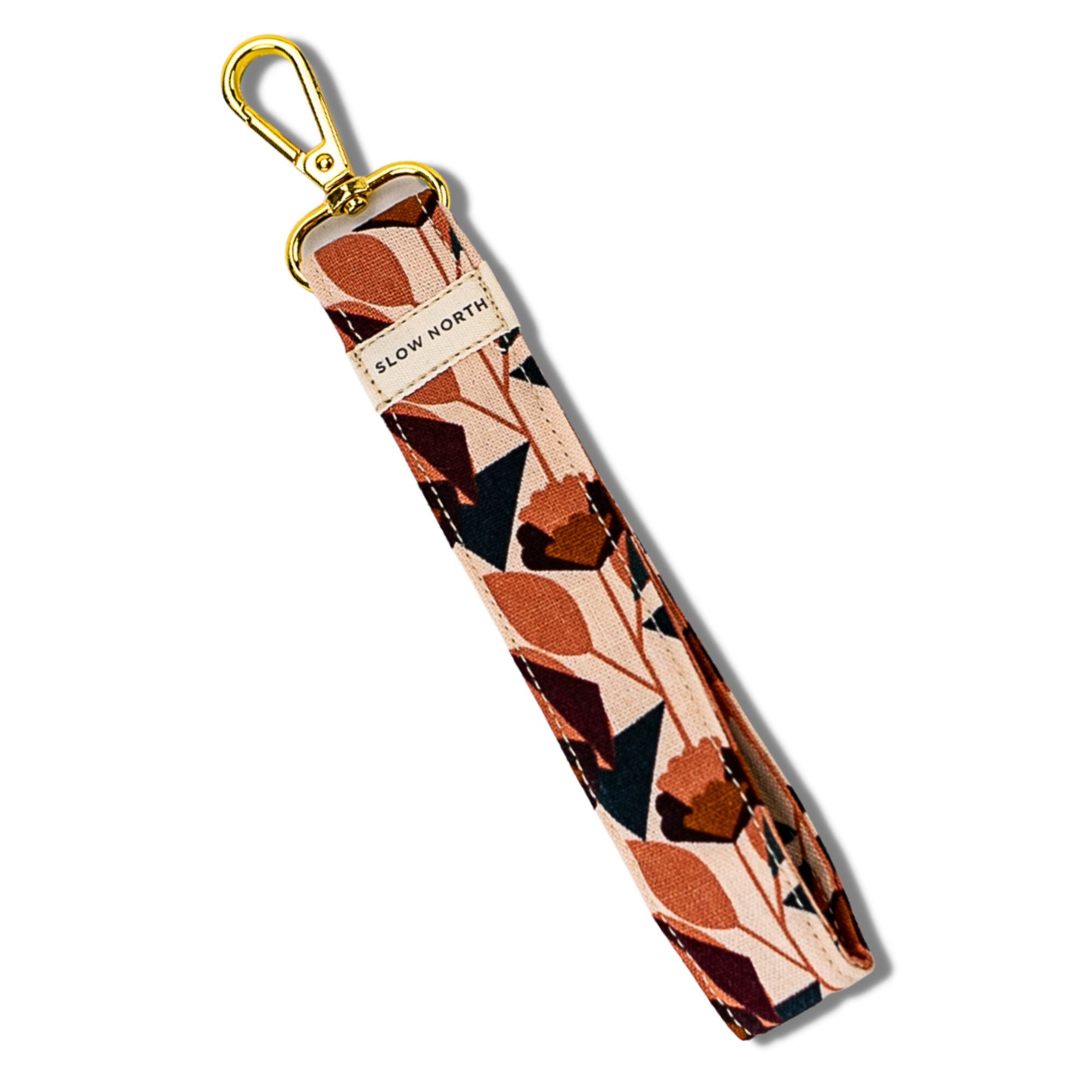 Patterned strap with gold clasp on a white background