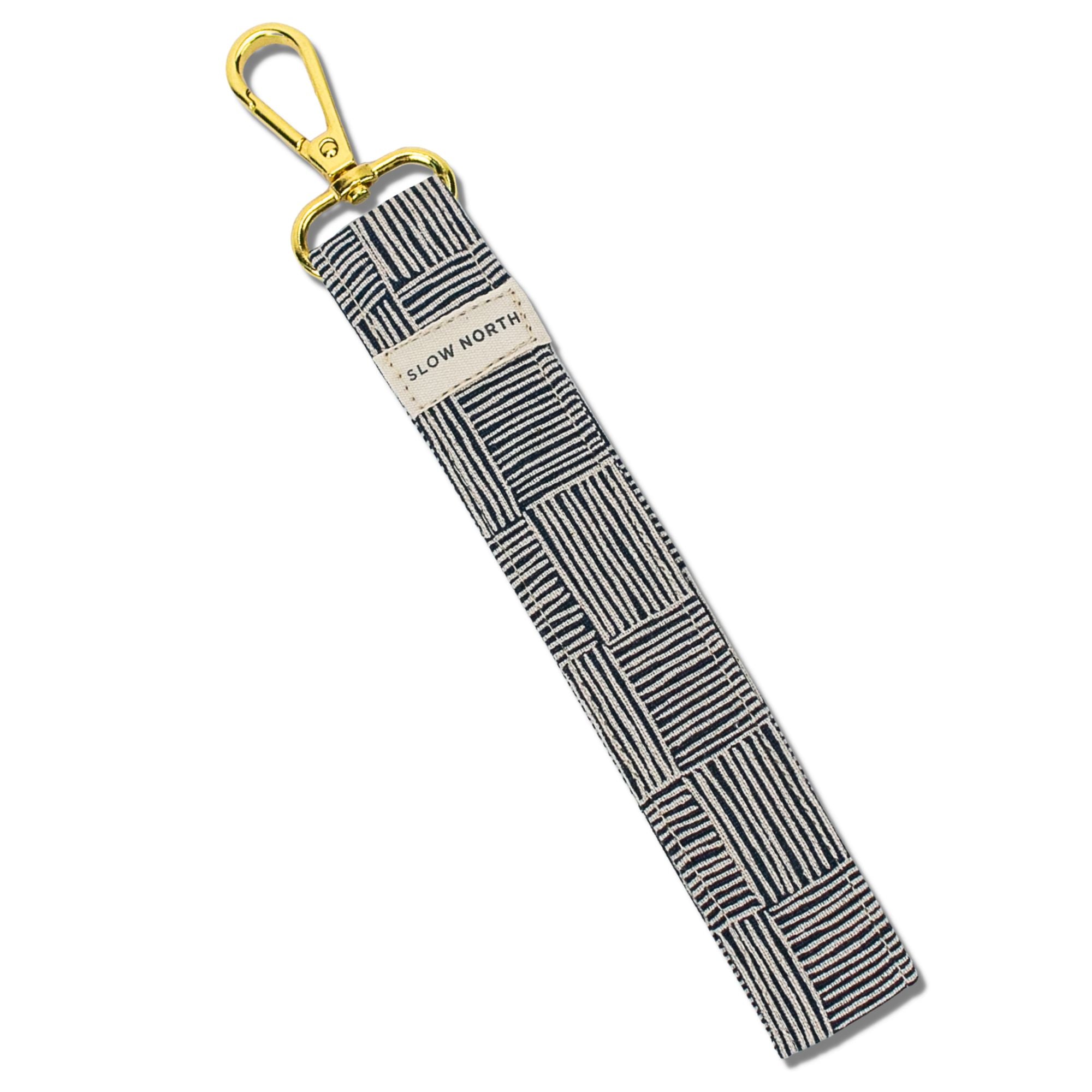 Striped keychain with gold clasp on a white background