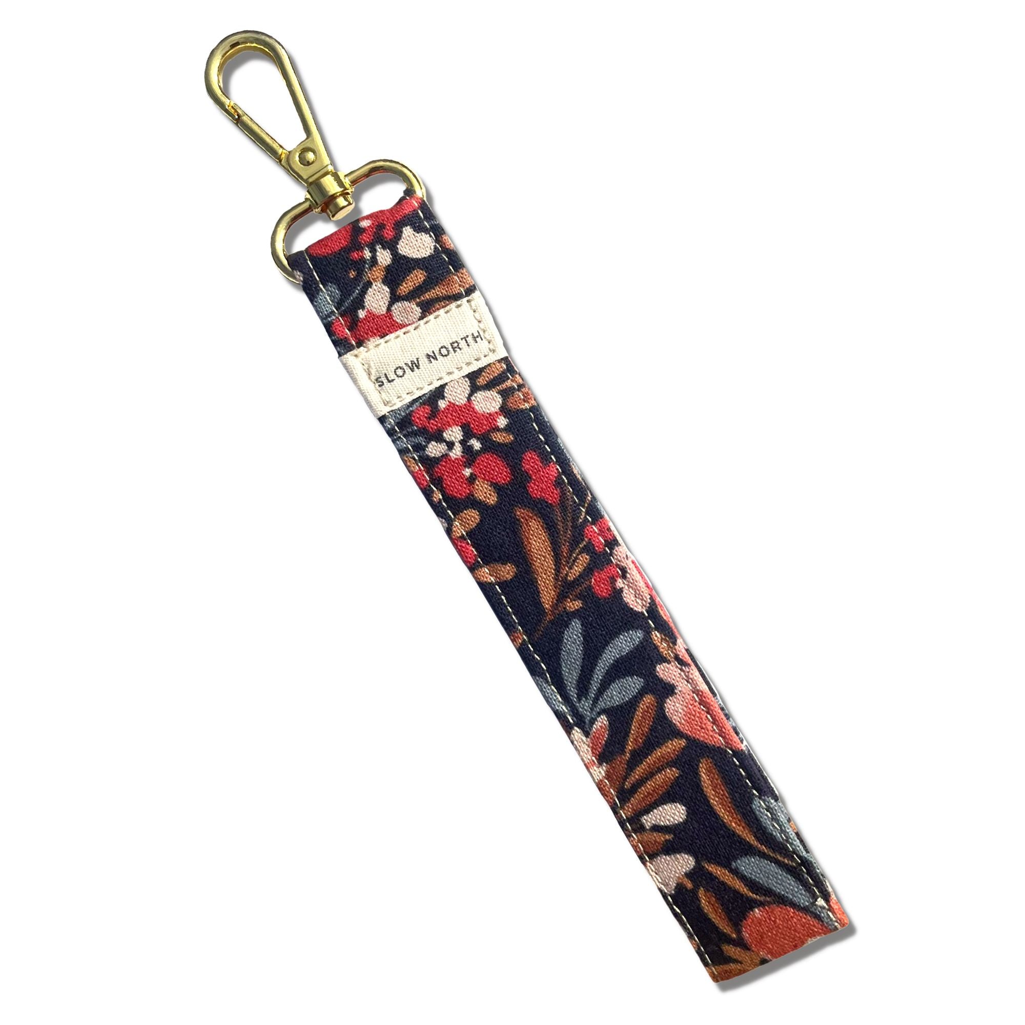 Floral patterned keychain with gold clasp on a white background